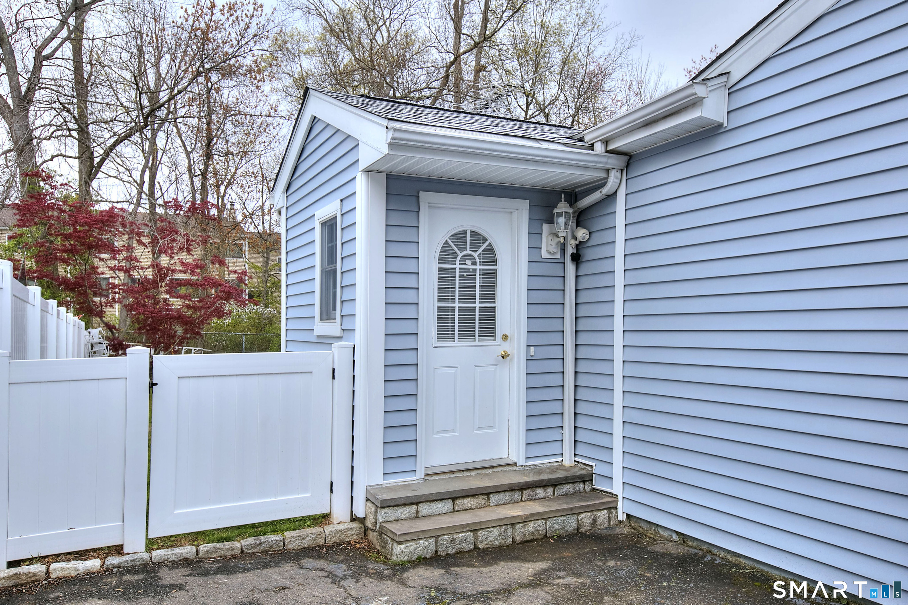 84 Youngstown Road Fairfield, CT 06824 - Photo 33 of 36 a view of a house with a door and a tree