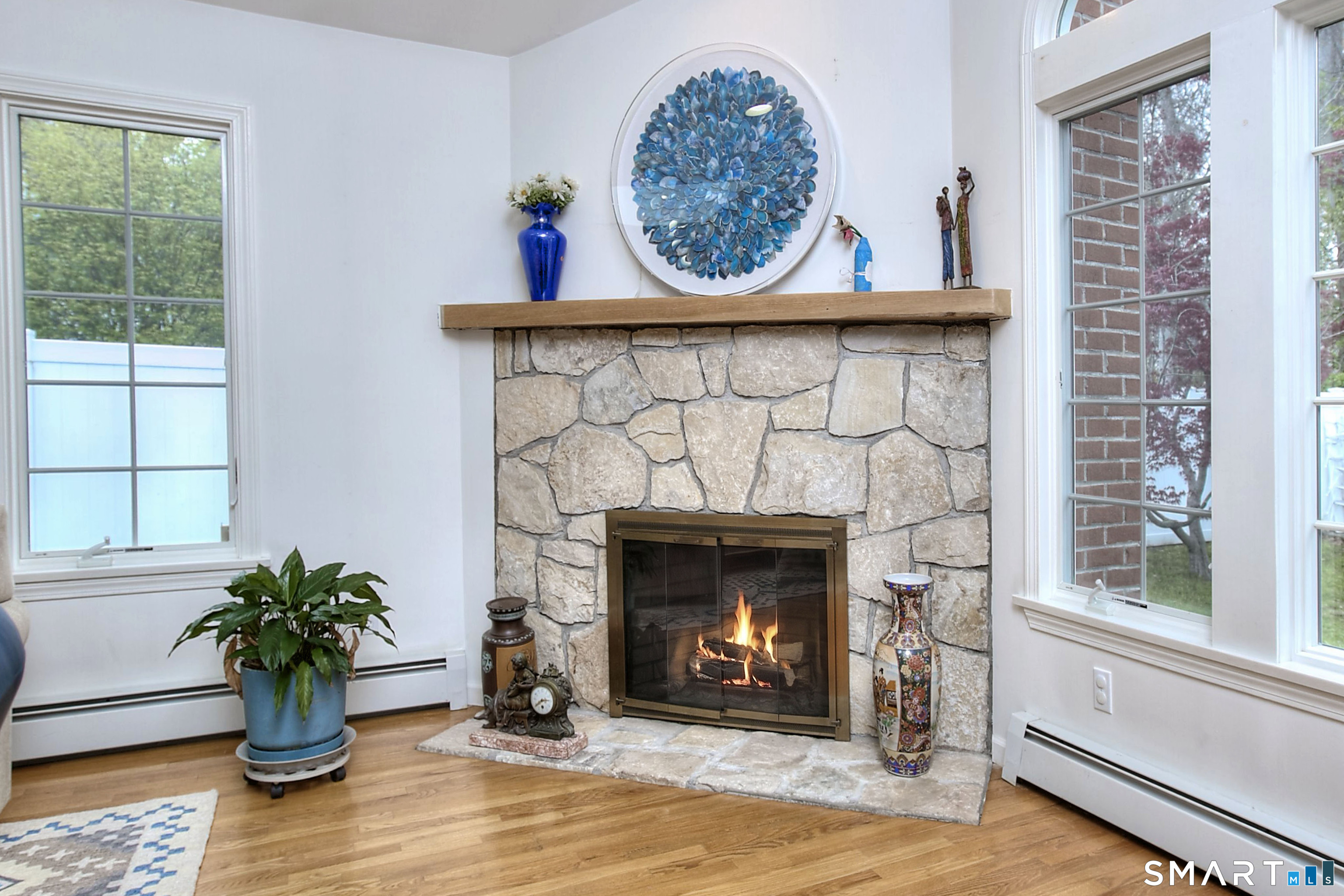 84 Youngstown Road Fairfield, CT 06824 - Photo 8 of 36 a living room with furniture and a fireplace