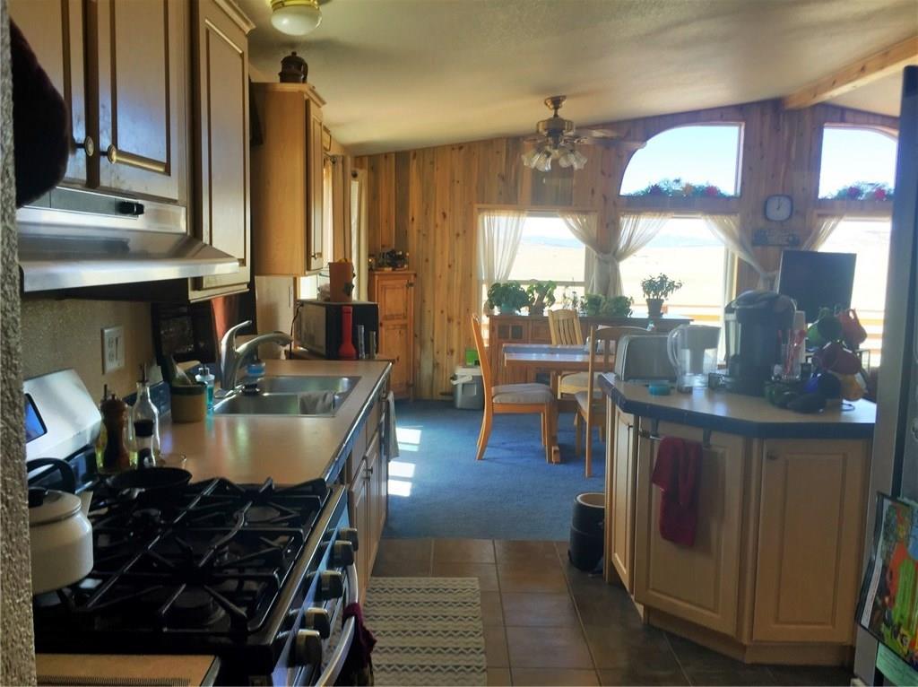 5868 Routt Road Hartsel, CO 80449 - Photo 15 of 25 a dining room with furniture and wooden floor