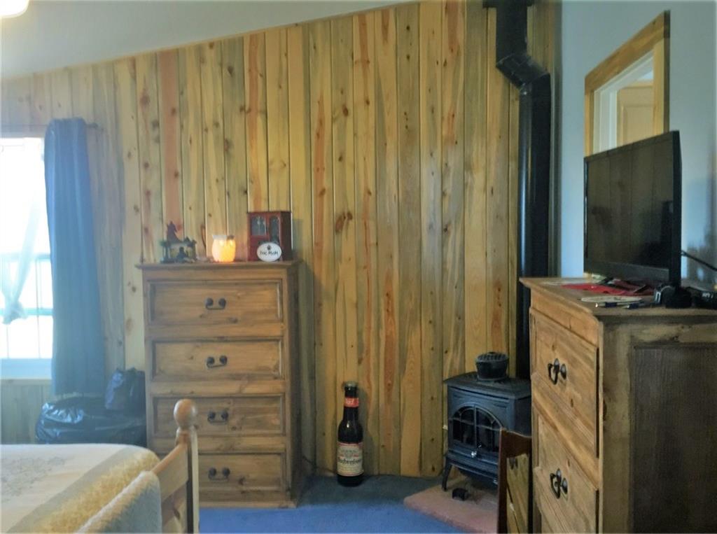 5868 Routt Road Hartsel, CO 80449 - Photo 7 of 25 a room with a dresser and a flat screen tv