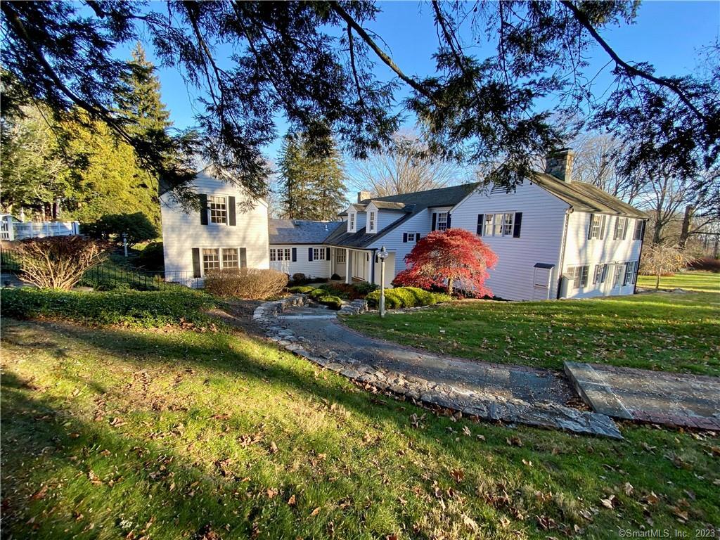 177 Good Hill Road Weston, CT 06883 - Photo 1 of 1 a front view of a house with a yard and fountain