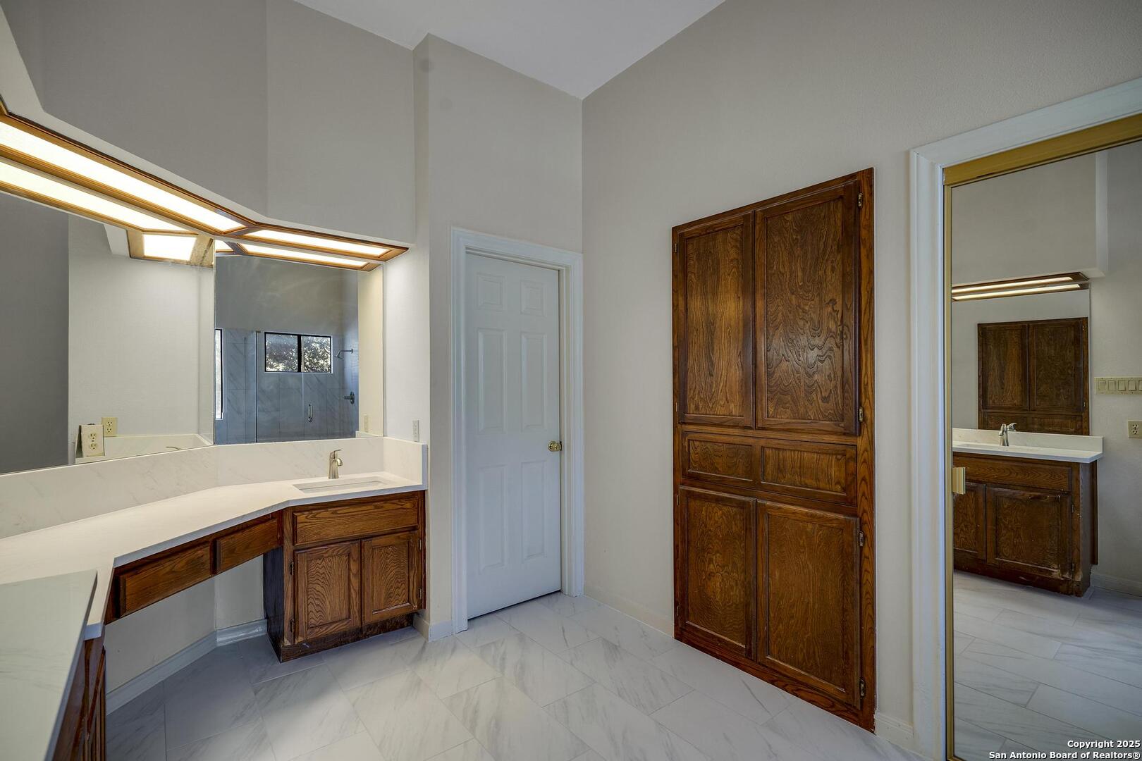 1603 Hawks Ridge Street San Antonio, TX 78248 - Photo 21 of 39 a room with a bed and a mirror