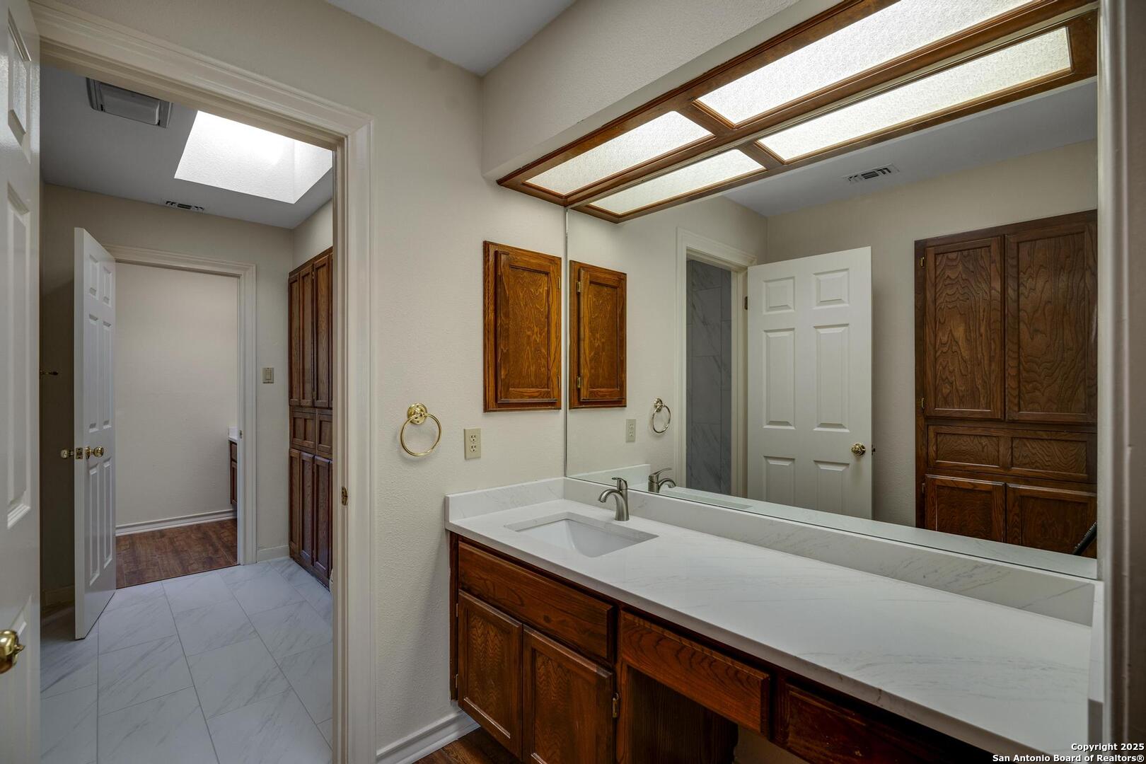1603 Hawks Ridge Street San Antonio, TX 78248 - Photo 28 of 39 a en suite bathroom with a sink double vanity and a mirror