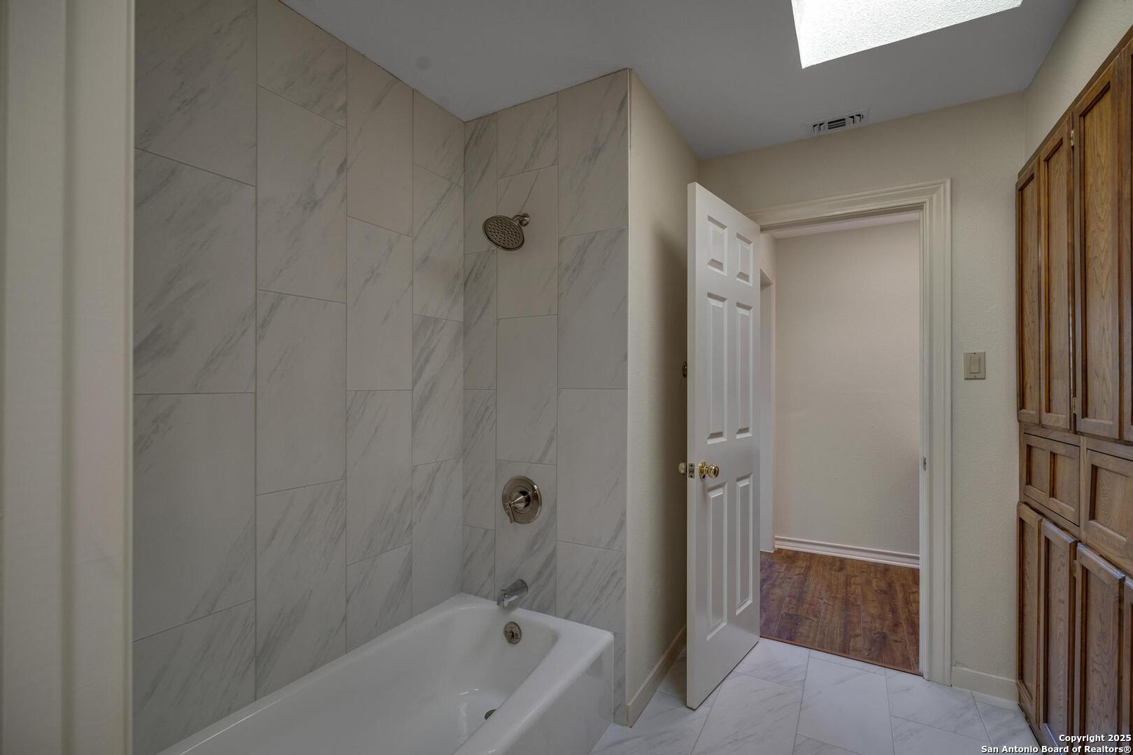 1603 Hawks Ridge Street San Antonio, TX 78248 - Photo 29 of 39 a bathroom with a tub shower vanity and a sink