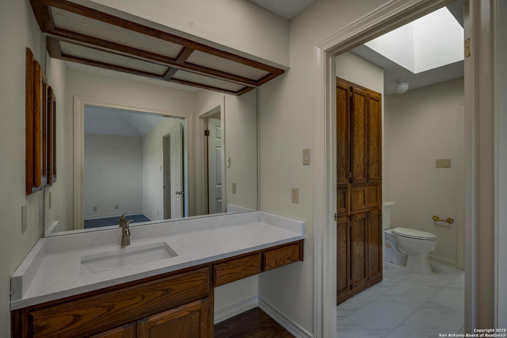 1603 Hawks Ridge Street San Antonio, TX 78248 - Photo 30 of 39 a bathroom with a sink a toilet and shower