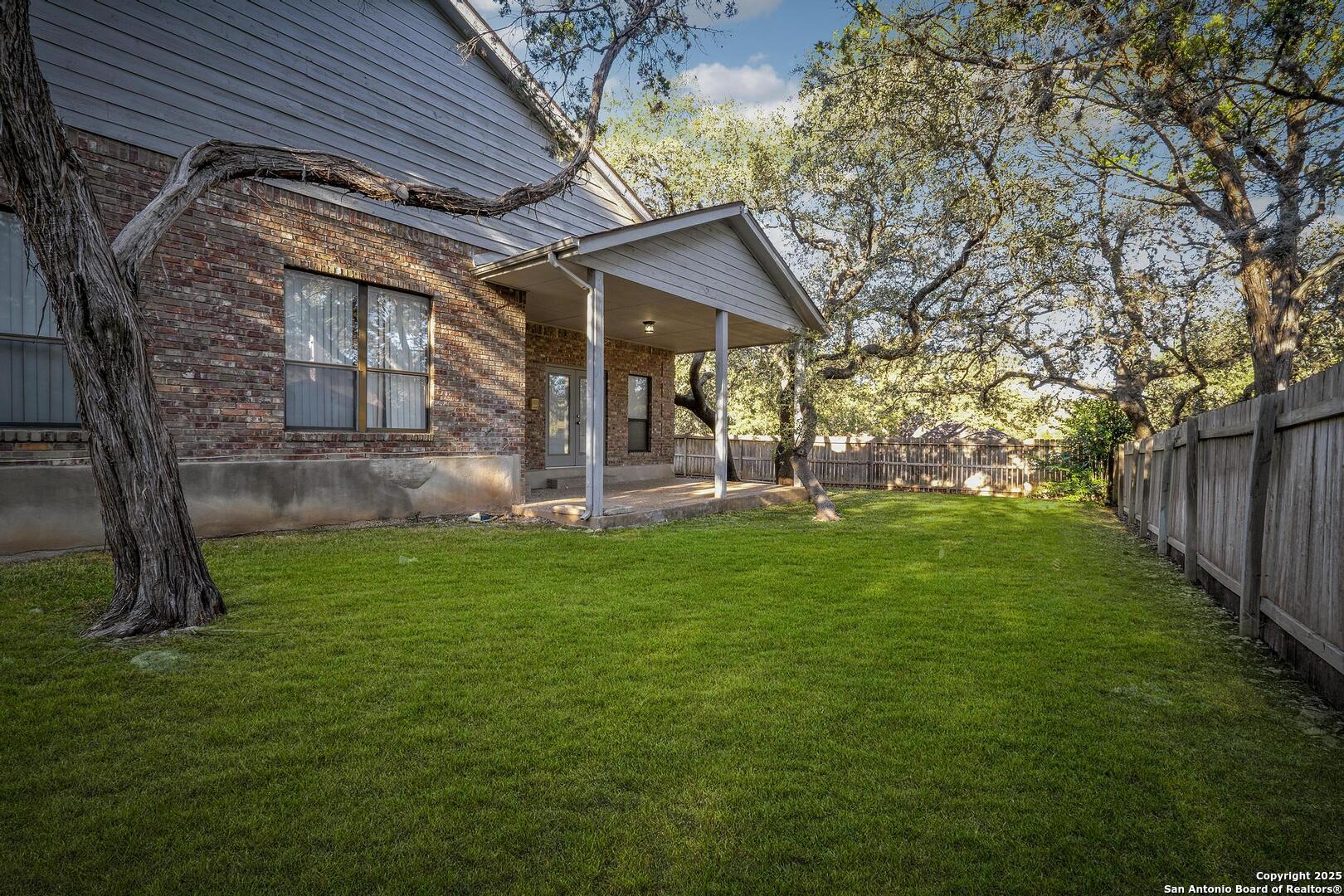 1603 Hawks Ridge Street San Antonio, TX 78248 - Photo 35 of 39 a view of a backyard with plants and large tree