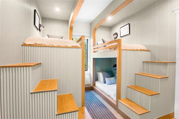 a bedroom with a large bed and a chandelier