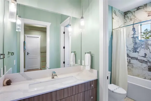 a bathroom with a sink toilet and shower