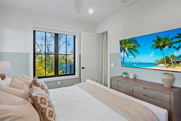 a bedroom with a bed and a flat screen tv