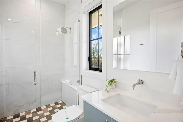 a bathroom with a sink vanity tub and shower