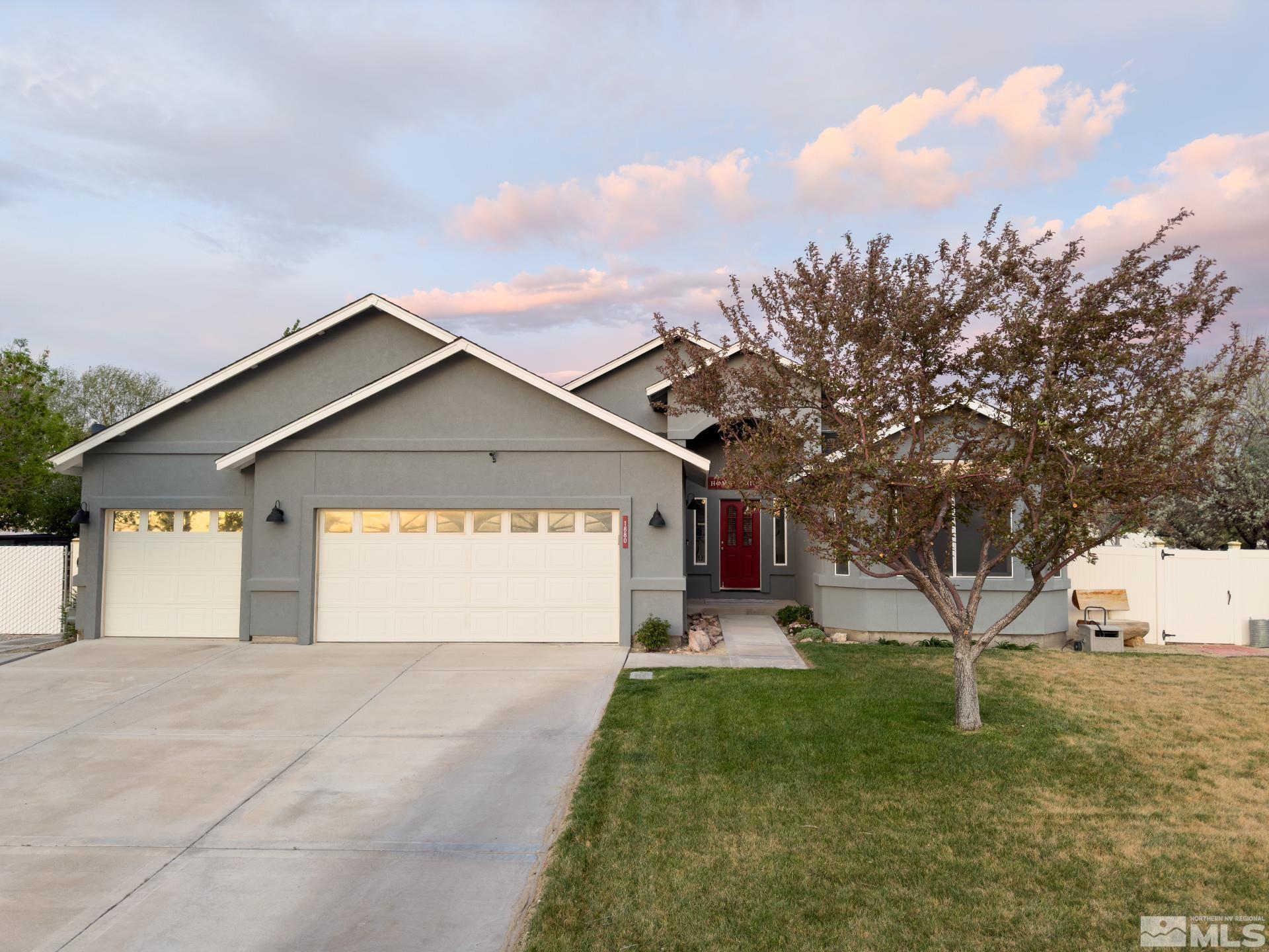 1880 Sky Ridge Drive Fallon, NV 89406 - Photo 4 of 40 a view of a house with a yard and garage