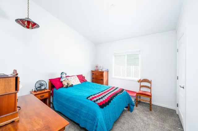 a bedroom with a bed and a dresser