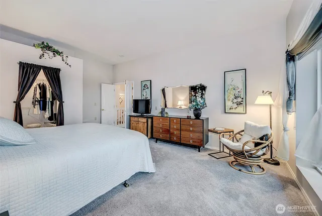 a spacious bedroom with a bed and window