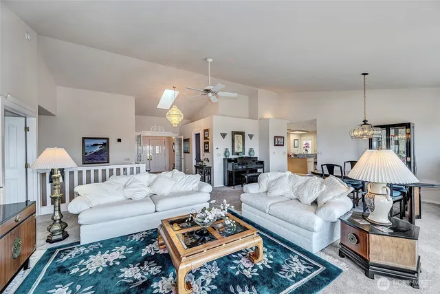 a living room with furniture a rug and a chandelier