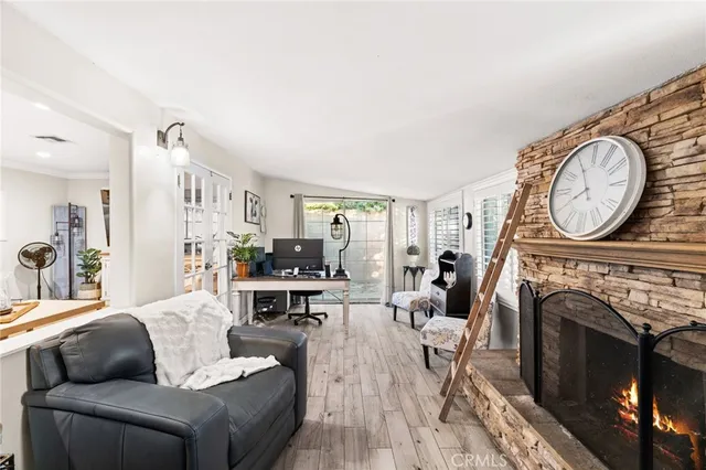 a living room with furniture a fireplace and a clock