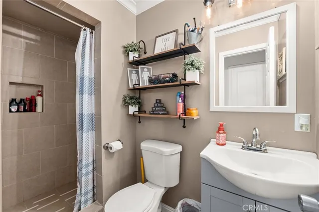 a bathroom with a sink mirror and toilet
