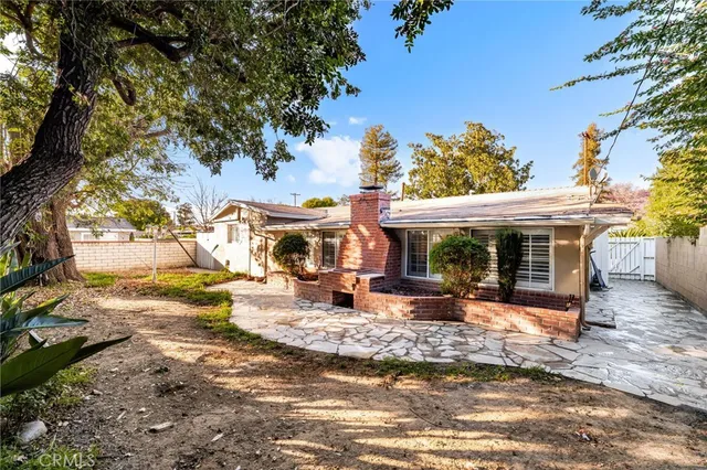 a view of a house with backyard porch and sitting area