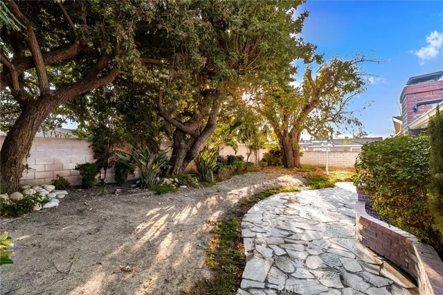 a view of a backyard with large trees