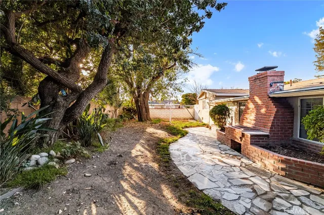 a row of palm trees in front of a house
