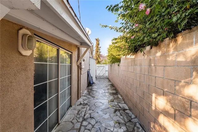 a view of a pathway gate with wooden fence
