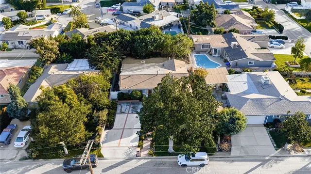 an aerial view of multiple houses with yard