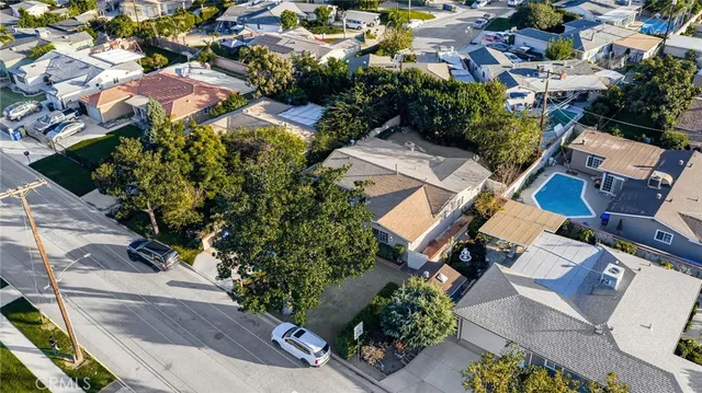 an aerial view of residential house with outdoor space and trees all around