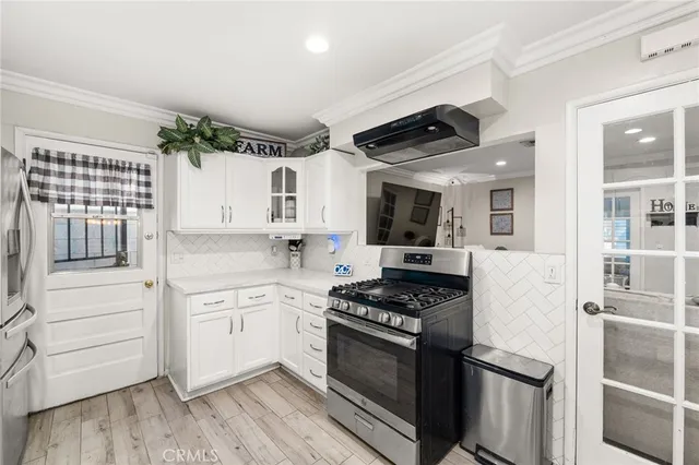 a kitchen with granite countertop cabinets stainless steel appliances and wooden floor