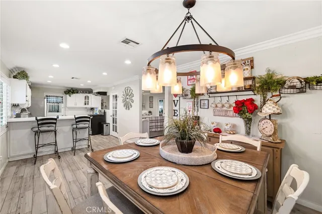 a very nice looking dining room with furniture and wooden floor