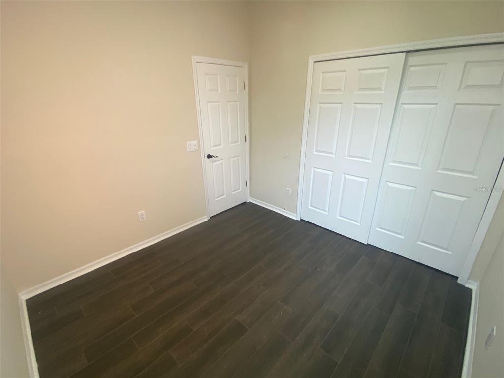 2409 Spring Hollow Loop Wesley Chapel, FL 33544 - Photo 18 of 47 an empty room with wooden floor