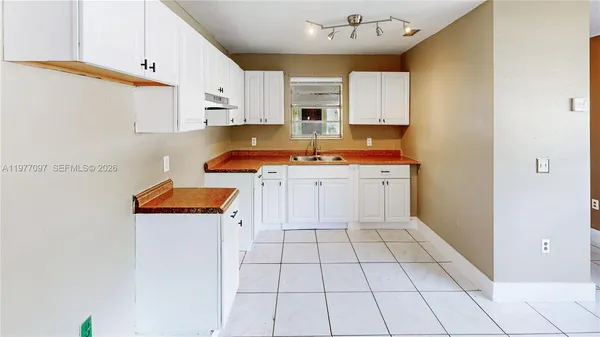a kitchen with stainless steel appliances a stove refrigerator sink and cabinets