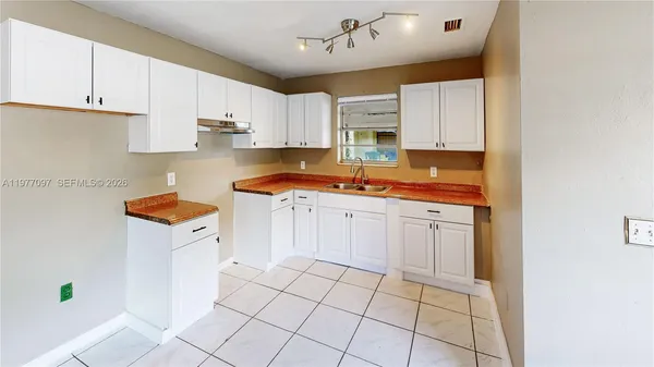 a kitchen with stainless steel appliances granite countertop a sink and cabinets