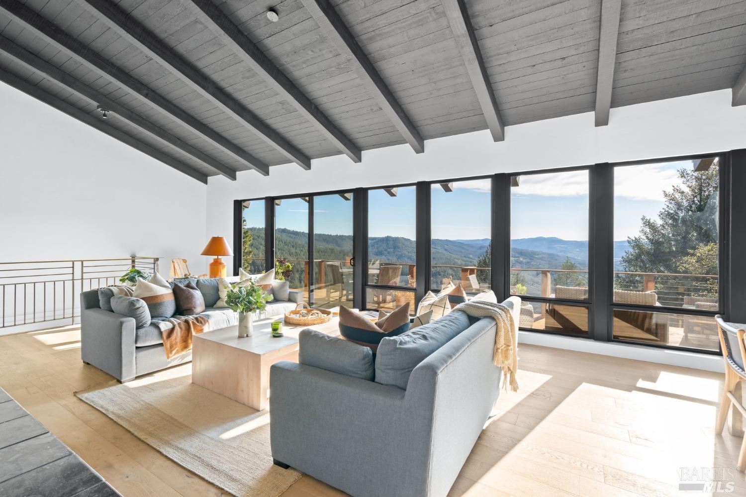 a living room with furniture and a floor to ceiling window