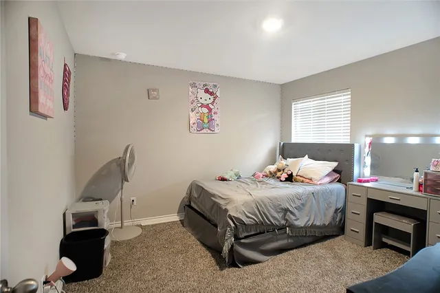 a bedroom with a bed and a dresser