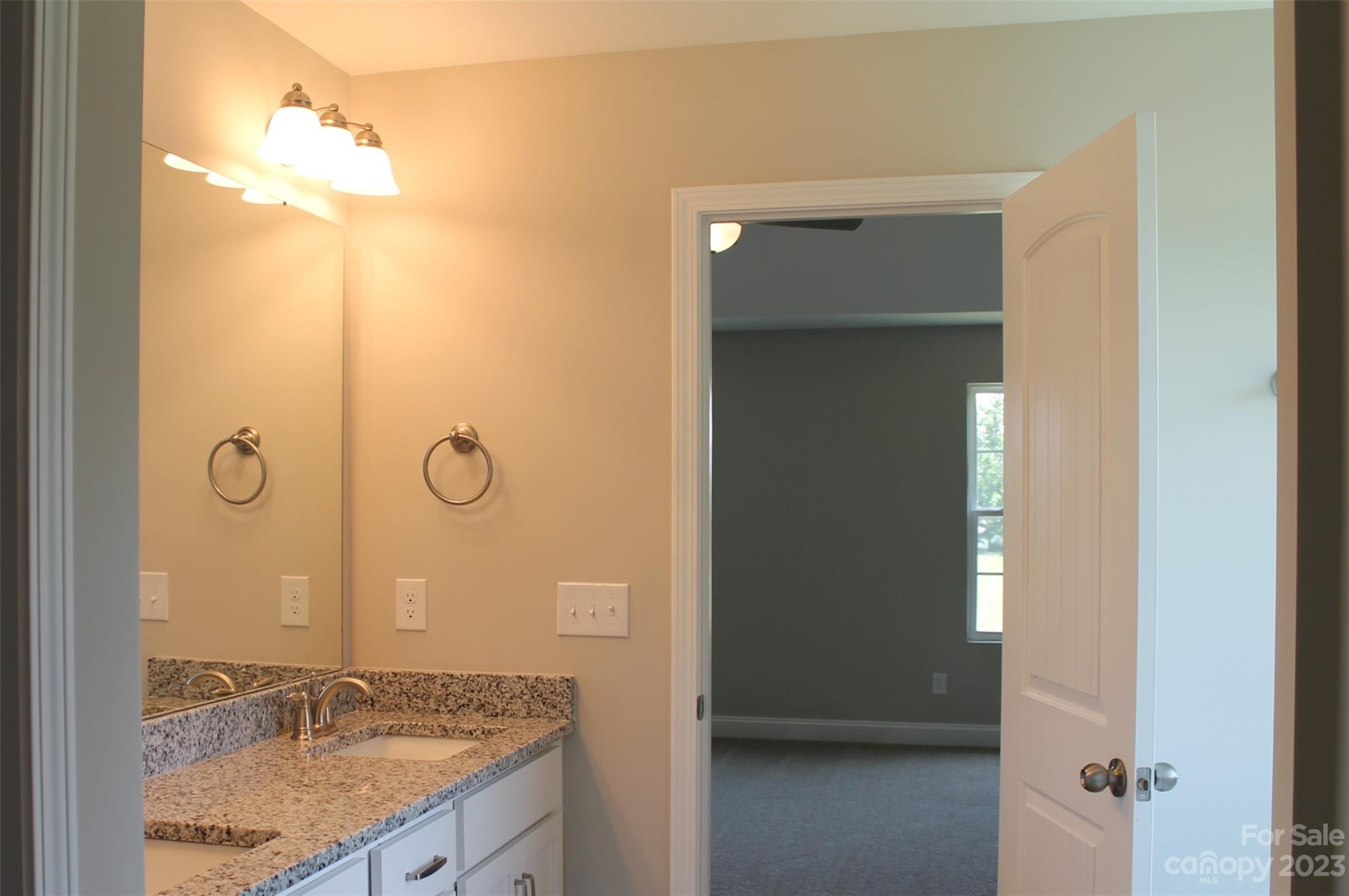 3818 New Salem Road Monroe, NC 28110 - Photo 13 of 15 a bathroom with a granite countertop sink a mirror and shower