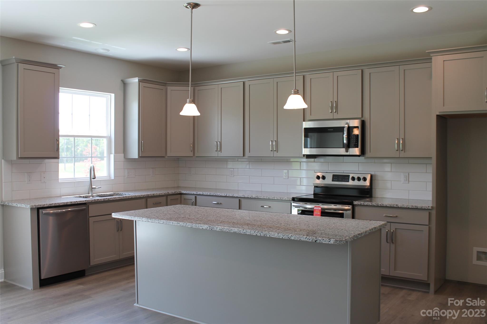 3818 New Salem Road Monroe, NC 28110 - Photo 3 of 15 a kitchen with kitchen island a sink stainless steel appliances and cabinets