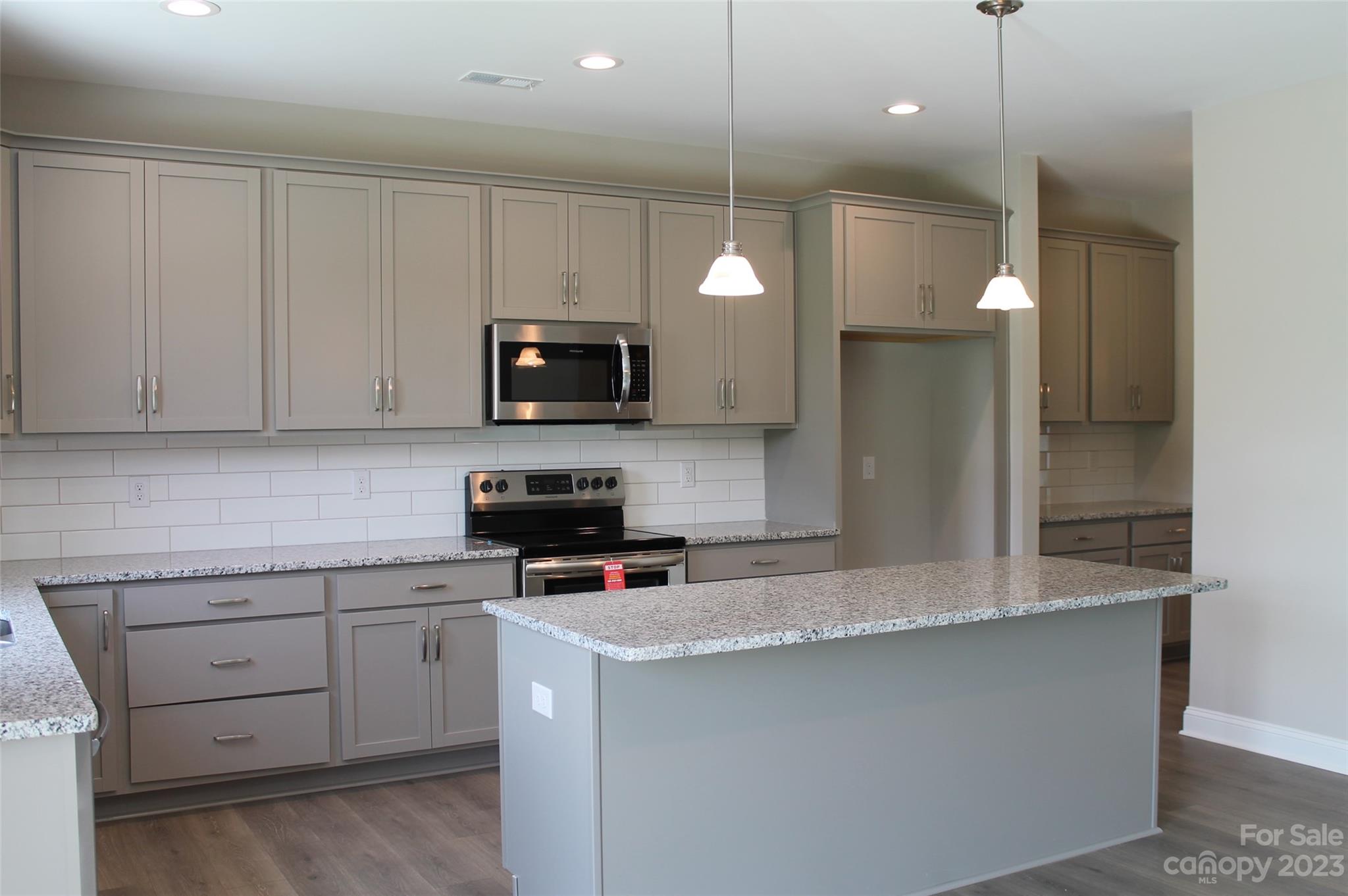3818 New Salem Road Monroe, NC 28110 - Photo 4 of 15 a kitchen that has a lot of cabinets and stainless steel appliances