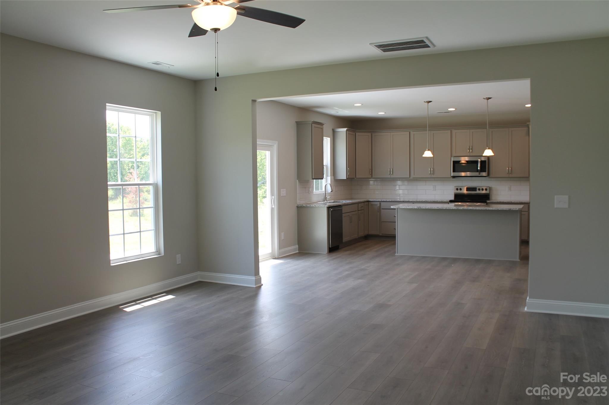 3818 New Salem Road Monroe, NC 28110 - Photo 7 of 15 a large kitchen with hardwood floor a sink and stainless steel appliances