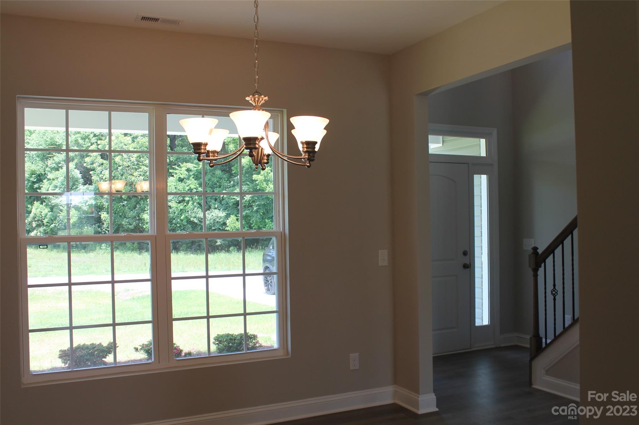3818 New Salem Road Monroe, NC 28110 - Photo 10 of 15 an empty room with wooden floor and windows