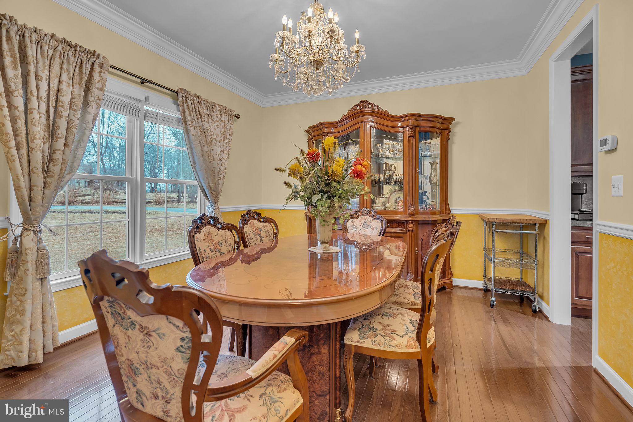 18631 Brick Store Road Hampstead, MD 21074 - Photo 11 of 64 a dining room with furniture a large window and wooden floor