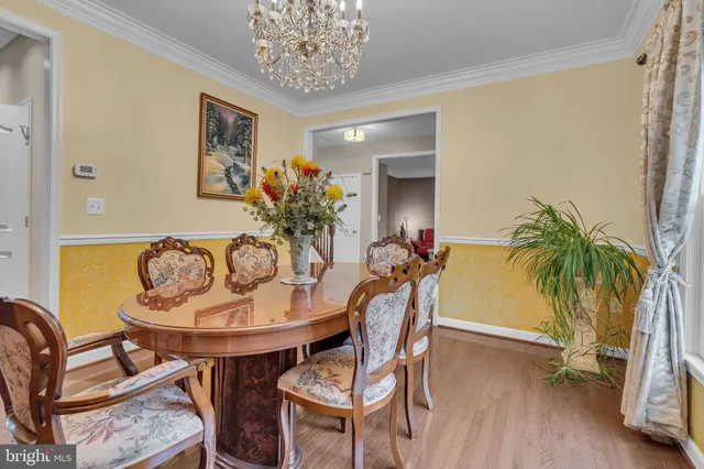 a kitchen with stainless steel appliances granite countertop a stove a sink and a granite counter tops with white cabinets