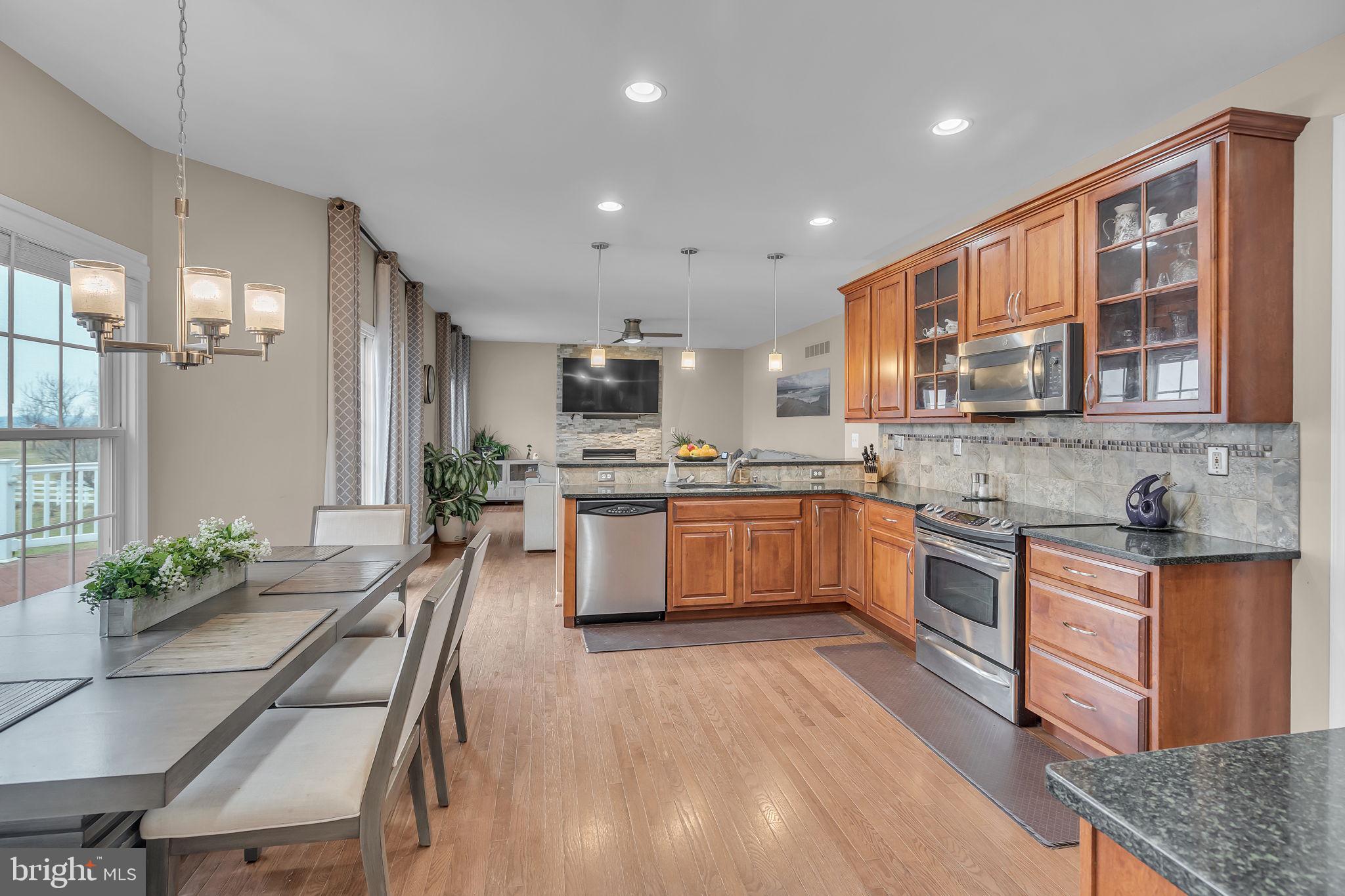 18631 Brick Store Road Hampstead, MD 21074 - Photo 16 of 64 a kitchen with stainless steel appliances granite countertop a stove refrigerator sink and cabinets