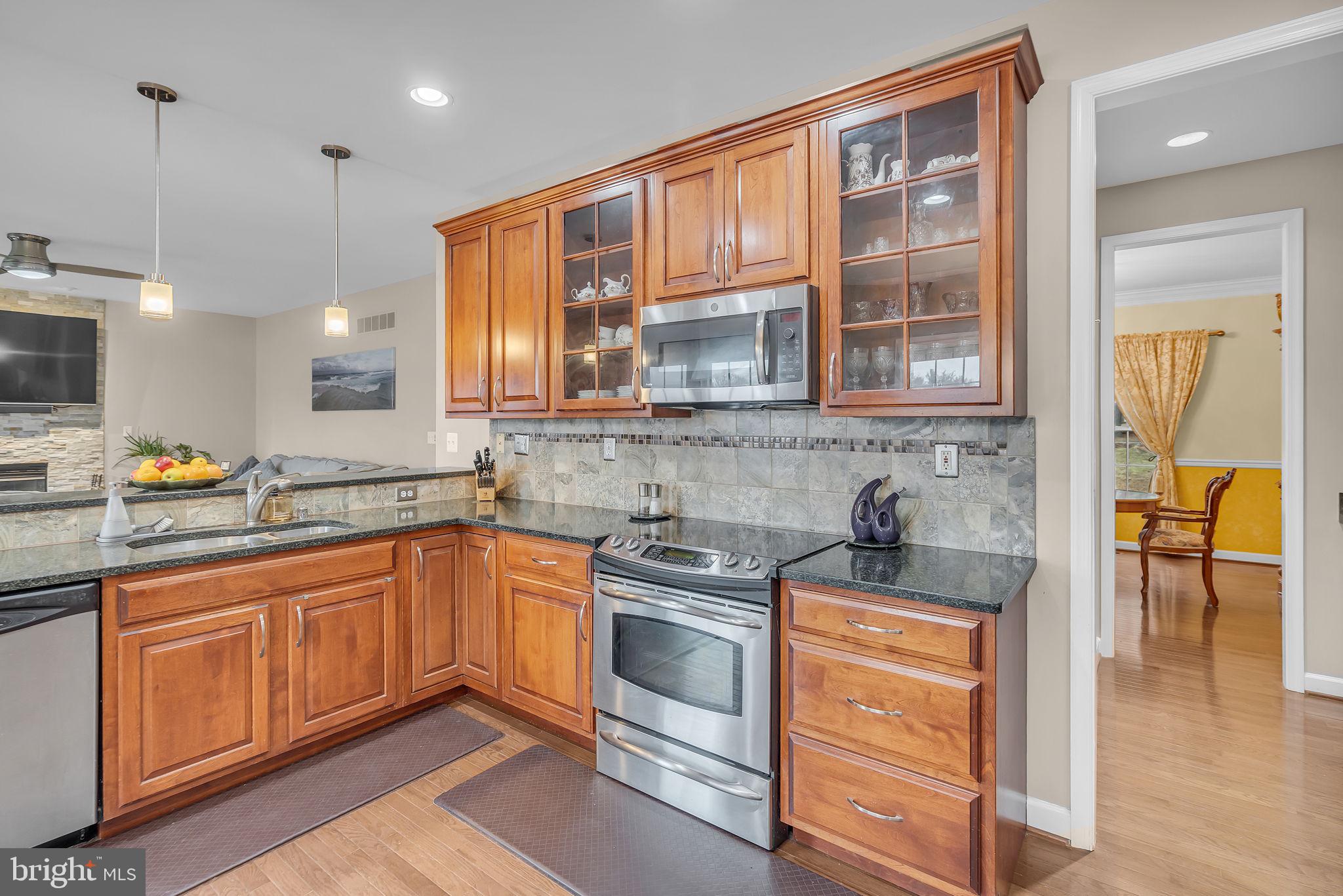 18631 Brick Store Road Hampstead, MD 21074 - Photo 17 of 64 a kitchen with stainless steel appliances granite countertop a stove and cabinets