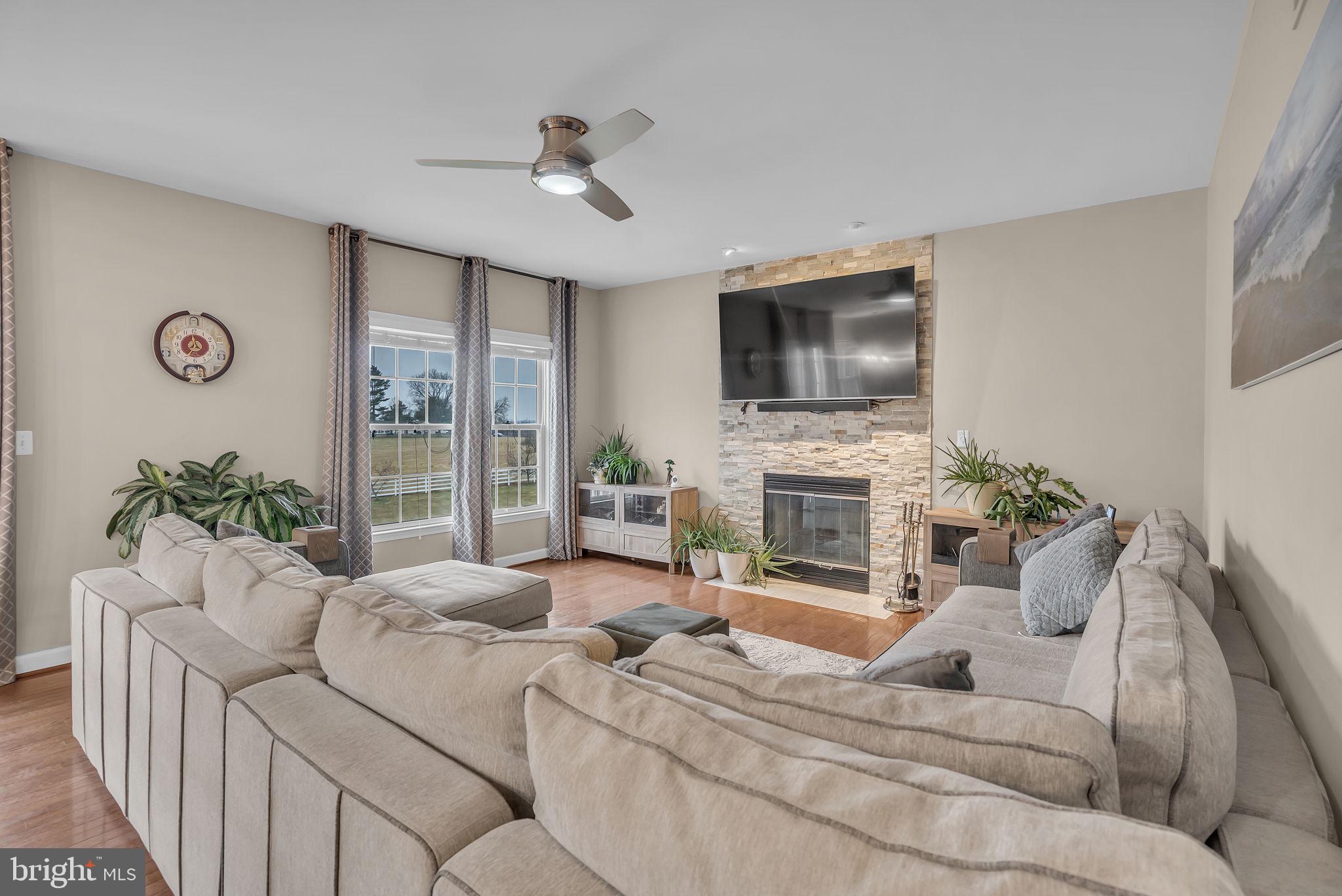 18631 Brick Store Road Hampstead, MD 21074 - Photo 22 of 64 a living room with furniture a fireplace and a flat screen tv