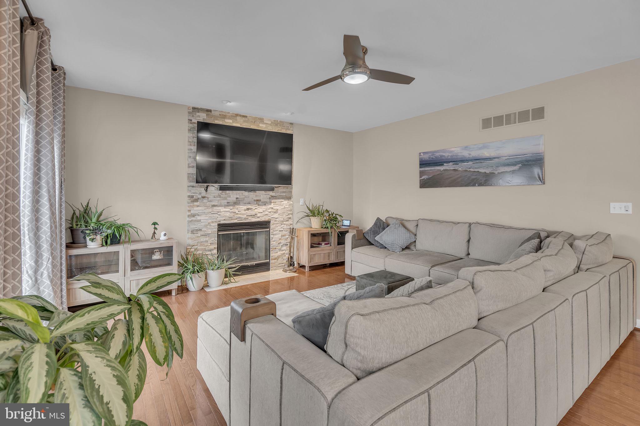 18631 Brick Store Road Hampstead, MD 21074 - Photo 23 of 64 a living room with furniture a fireplace and a flat screen tv