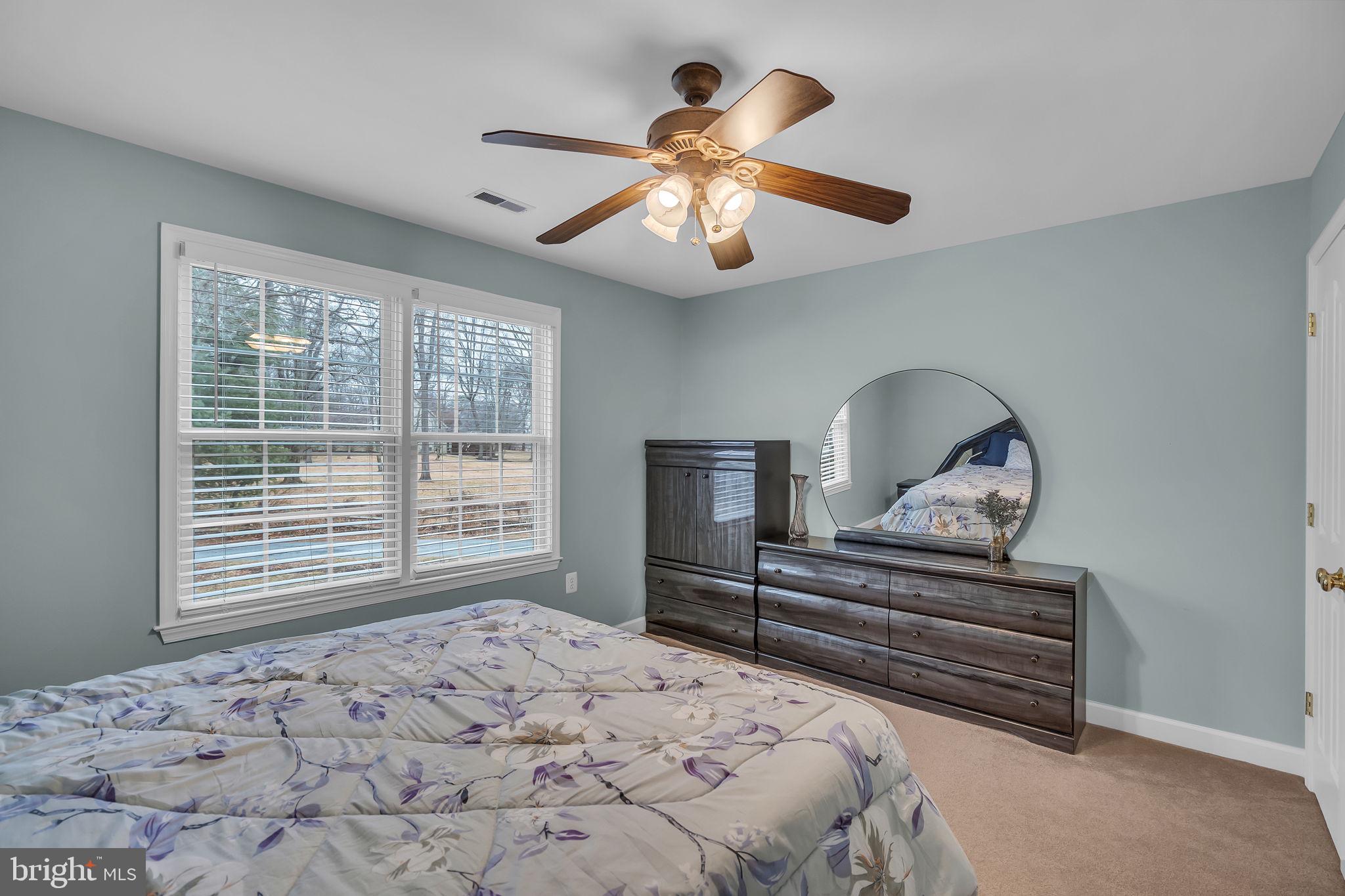 18631 Brick Store Road Hampstead, MD 21074 - Photo 36 of 64 a bedroom with a bed and a chandelier