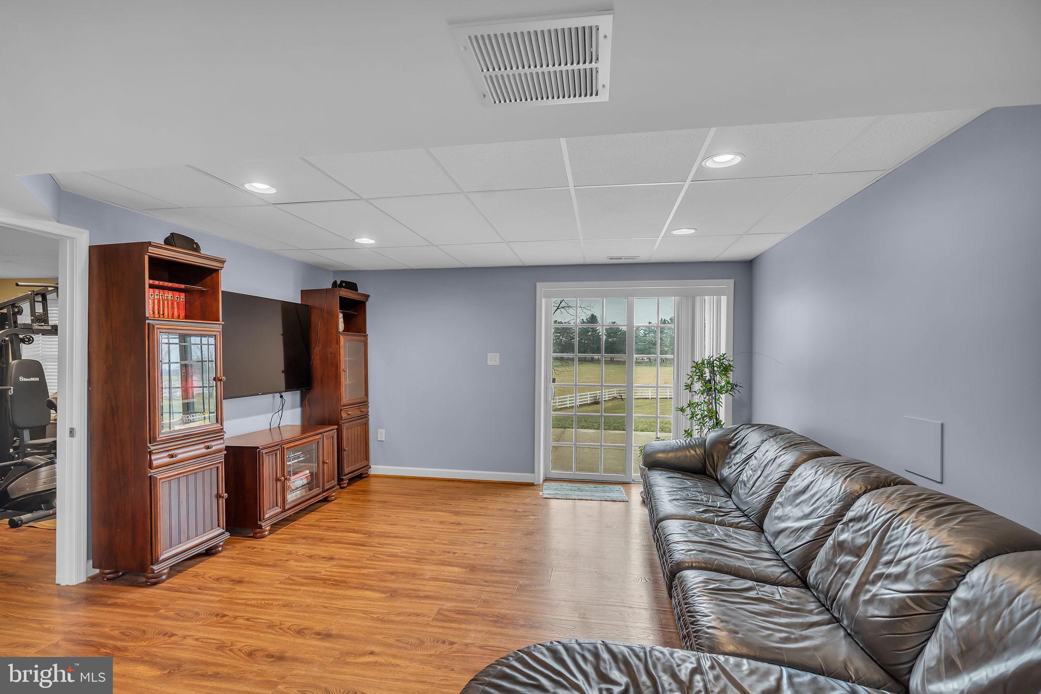 18631 Brick Store Road Hampstead, MD 21074 - Photo 40 of 64 a living room with furniture and a flat screen tv