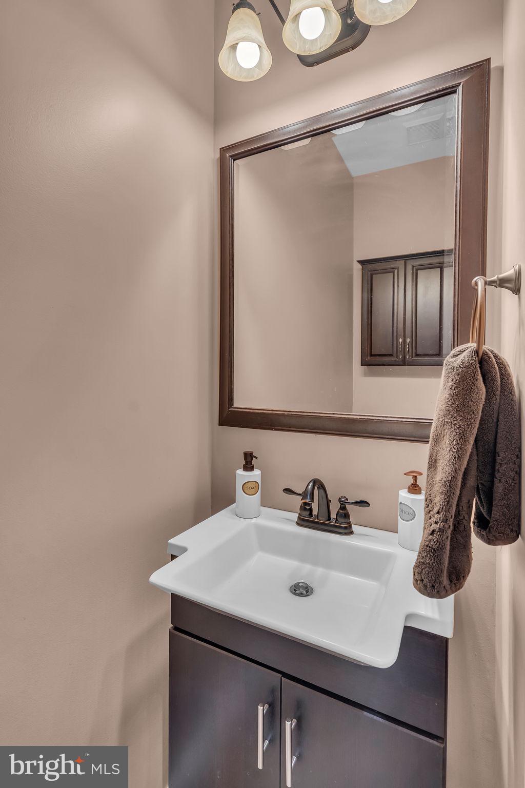 18631 Brick Store Road Hampstead, MD 21074 - Photo 43 of 64 a bathroom with a sink vanity and mirror