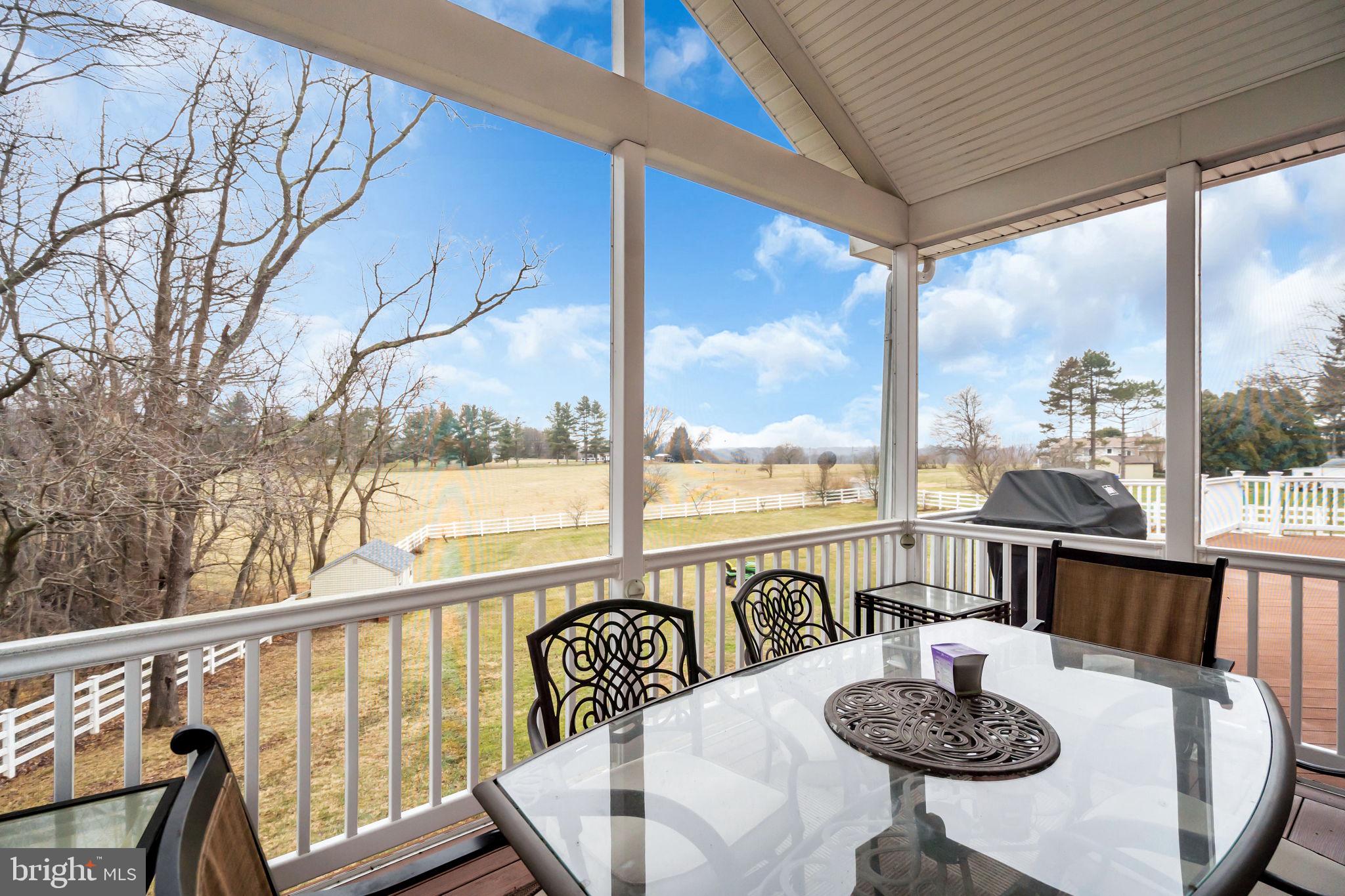 18631 Brick Store Road Hampstead, MD 21074 - Photo 48 of 64 a view of a balcony dining table and chairs