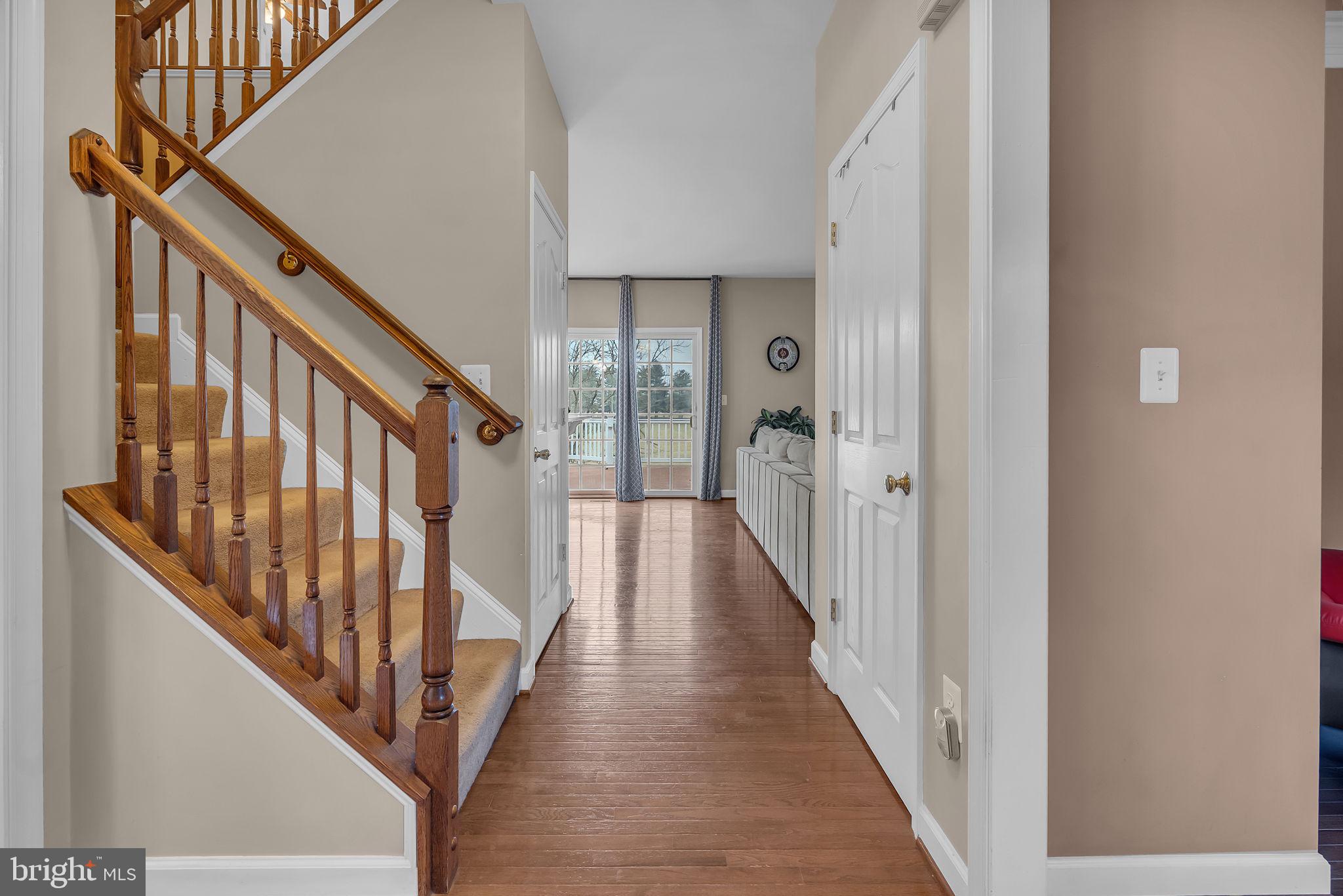 18631 Brick Store Road Hampstead, MD 21074 - Photo 7 of 64 a view of a hallway with wooden floor and staircase