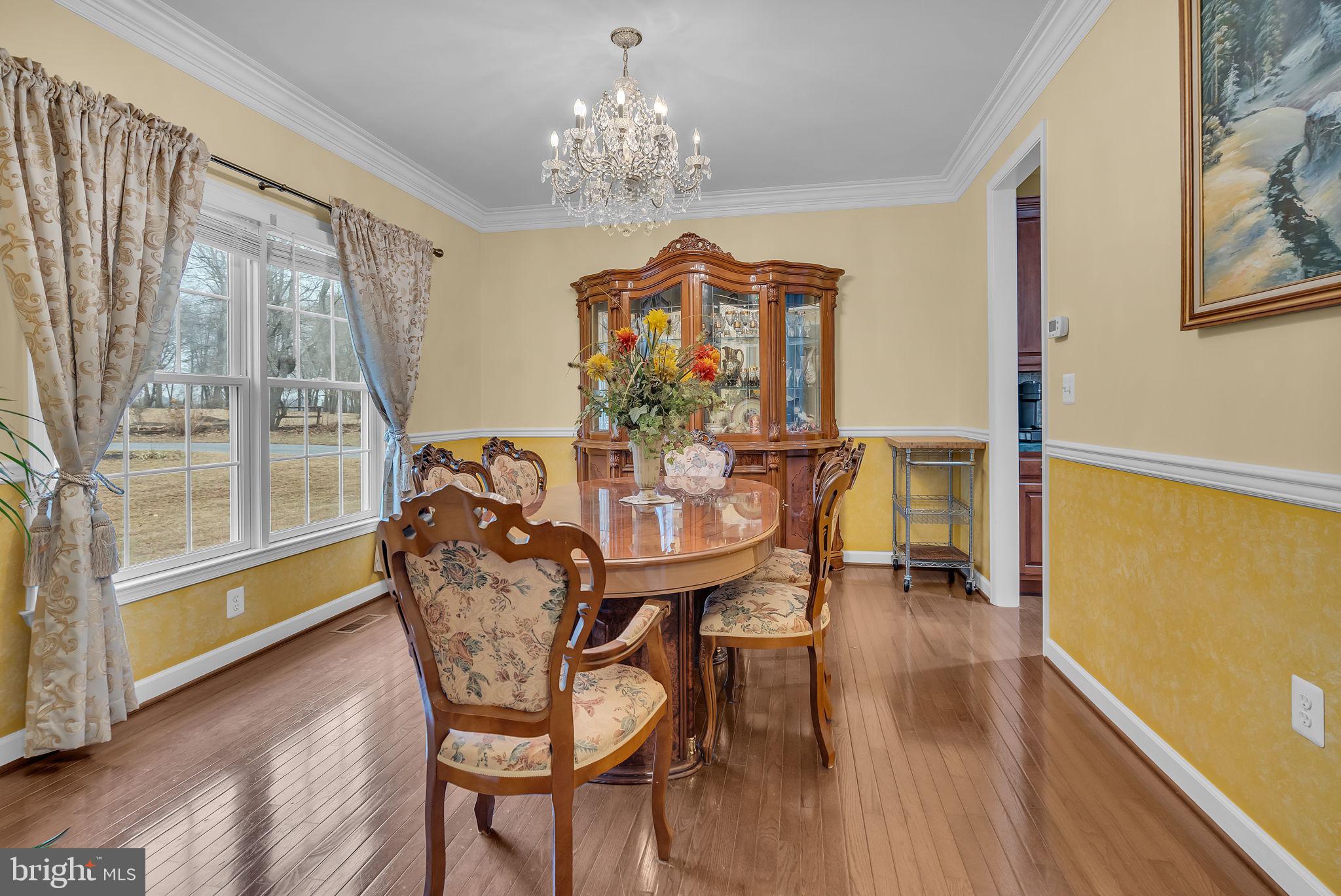 18631 Brick Store Road Hampstead, MD 21074 - Photo 10 of 64 a view of a dining room with furniture and chandelier
